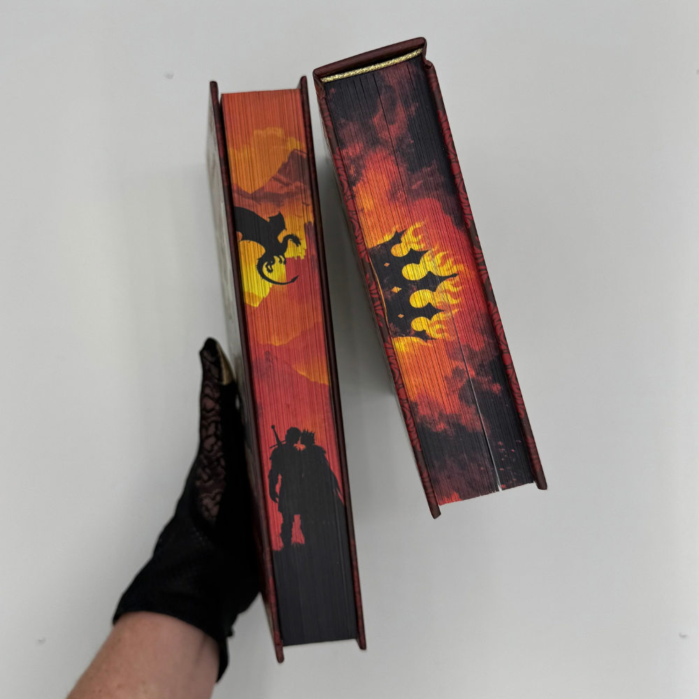 Talons & Treason hardcover sprayed edges showing a dragon, a crown, and a couple in silhouette