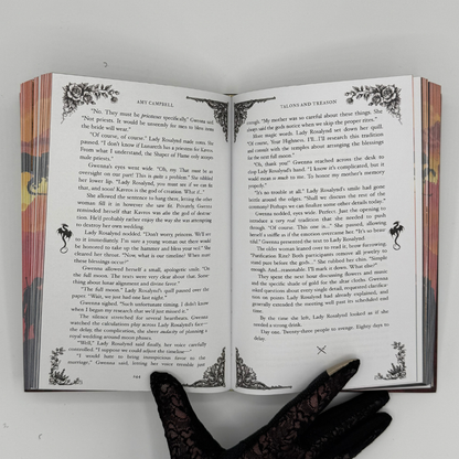 Talons & Treason interior pages with ornate dragon flourishes and decorative corners